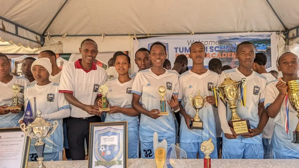 Tumaini Sports Academy students with trophies and certificates
